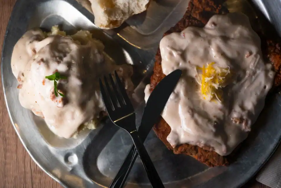 Biscuits and chicken fried steak smothered in gravy
