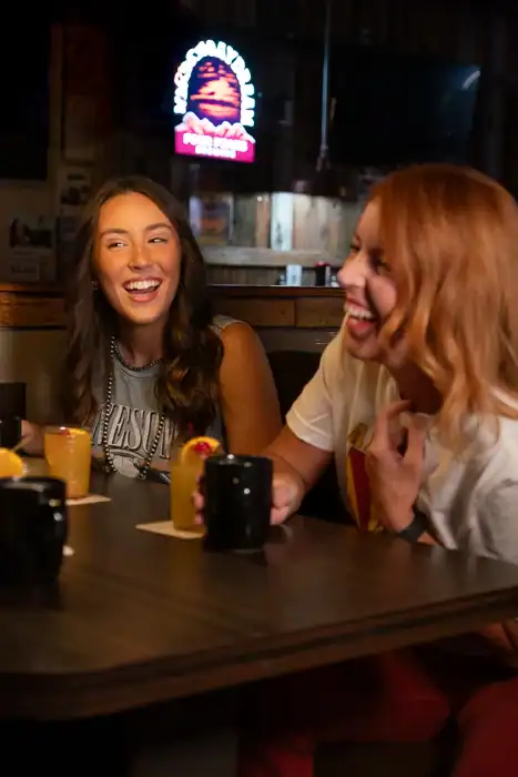 Friends laughing and enjoying coffee at Q Bar
