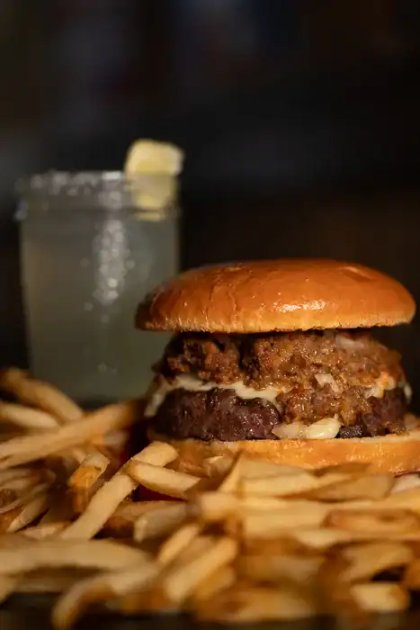 Q Burger with fries and a mini margarita in the background